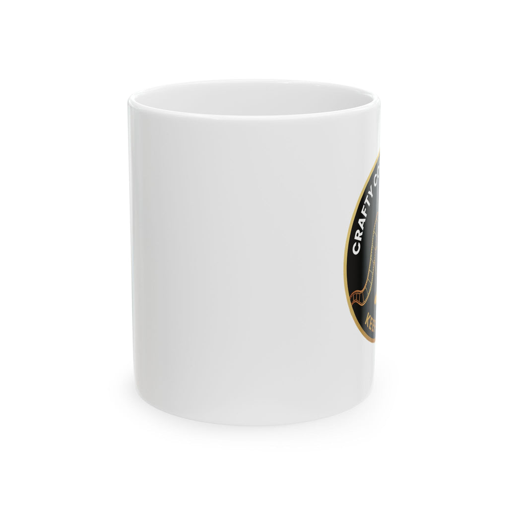 White mug with a Crafty Coffee Company logo on a white background (side view)